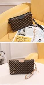 Detail of vintage round print crossbody bag with metal chain strap and top handle
