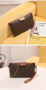 Detail of vintage circle pattern mini crossbody bag with gold chain and wristlet strap