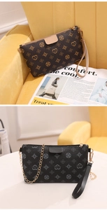 Detail of printed crossbody bags with heart patterns, chain strap and wristlet