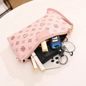 Pink chain crossbody bag with floral prints showing its large interior capacity