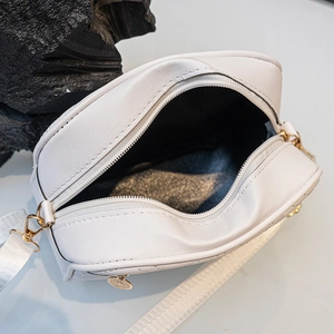 White V-pattern crossbody camera bag with adjustable strap and zip closure internal view