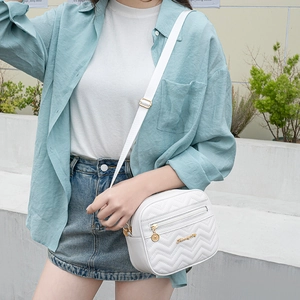 White quilted crossbody bag with V-shaped stitching and gold metal logo for women