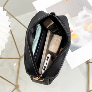 Black quilted crossbody bag with internal storage for cosmetics and power bank