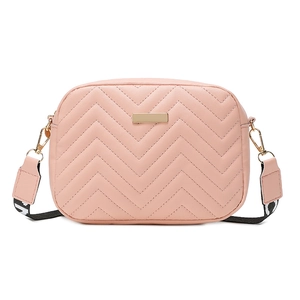 Pink chevron quilted crossbody camera bag with gold logo plate and woven guitar strap