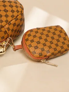 Close-up of brown textured leather bag with floral print and gold metal hardware hooks