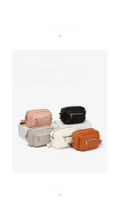 Detail showing five colors of mini crossbody bags with adjustable fabric straps
