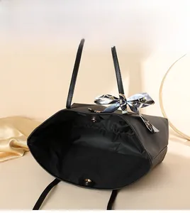 Interior view of black tote bag showing spacious lining, magnetic snap and silk scarf