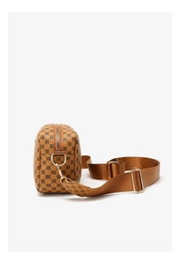 Side view of small square crossbody bag with brown geometric print and adjustable strap