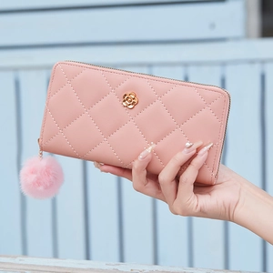 Pink quilted long wallet for women with golden flower decor and fluffy pompom keychain