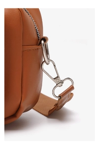 Detailed close-up of brown leather bag featuring silver metal zipper and hardware