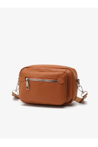 Detail of caramel brown crossbody bag showing smooth leather texture and metal D-rings