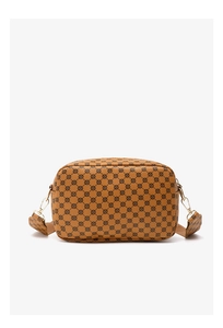 Close-up of brown camera bag with geometric floral print and wide fabric shoulder strap