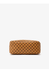 Detail of tan faux leather shoulder bag featuring black textured clover pattern and grain
