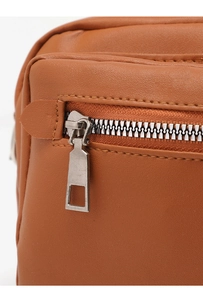 Detail of brown litchi pattern leather shoulder bag with silver metal zipper and stitching