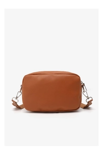 Detail view of caramel brown leather crossbody bag with silver zipper and metallic hooks