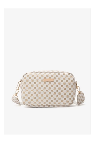 Close-up of cream square camera bag with brown geometric patterns and gold metal plate