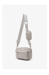 Detail of light grey crossbody bag with detachable coin purse on a wide fabric strap
