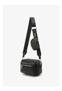 Detail view of black nylon crossbody bag featuring round coin pouch and silver zippers