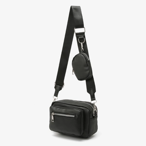 Minimalist black nylon crossbody bag with adjustable wide strap and mini round coin pouch