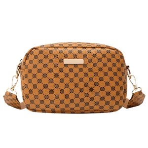 Retro brown crossbody bag with clover pattern and wide shoulder strap on white background