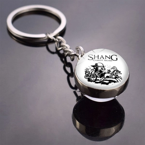 Macro detail of silver metal keychain with glass dome pendant featuring Shang Chariot Archer