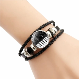 Bracelet en cuir tressé touches de piano avec notes de musique sur fond blanc