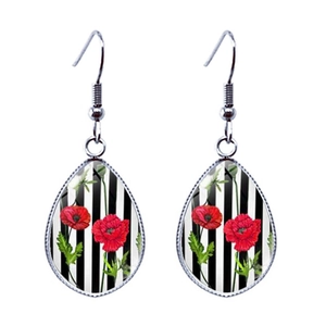 Red poppy flower teardrop earrings with artistic black and white striped background