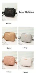 Close-up of quilted camera bag featuring V-shaped stitching and gold metal plate