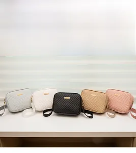 Detailed view of 5 quilted camera bags in assorted colors with wide fabric straps