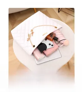 Spacious interior of white quilted bucket bag showing room for phone and essentials