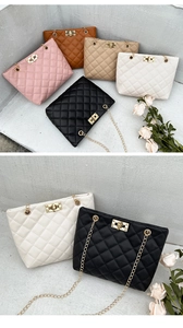 Detail view of quilted cross-body bucket bags in multiple colors with golden chain and lock