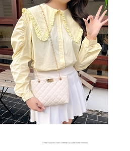 Detail of beige quilted shoulder bag with gold chain strap and elegant turn-lock closure