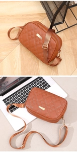 Brown quilted crossbody camera bag with adjustable strap and gold metal hardware
