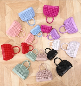 Hollow jelly shell bags in various sizes and colors displayed on a light wood floor