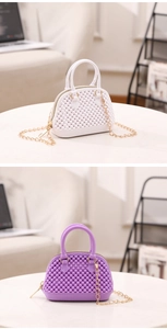Detail of mini PVC shell bag showing textured bead surface and gold chain strap