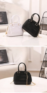Detail of mini PVC shell bags in black and white with 3D beaded texture and gold chain