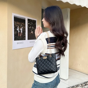 Classic black quilted shoulder bag with gold chain strap and diamond lattice texture