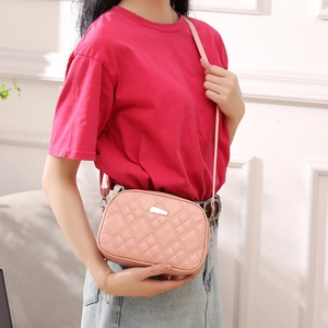 Pink quilted crossbody phone bag with gold metal plaque and stylish thin shoulder strap