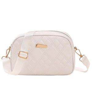 White quilted crossbody camera bag with gold hardware and wide adjustable strap