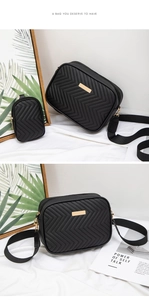 Close-up of black V-quilted camera bag with golden metal plate and mini coin purse detail