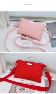 Detail view of pink and red quilted crossbody bags with adjustable wide shoulder straps