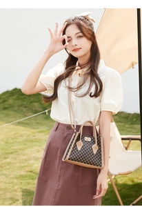 Close-up of the geometric circular pattern and golden turn-lock on the mini Kelly bag