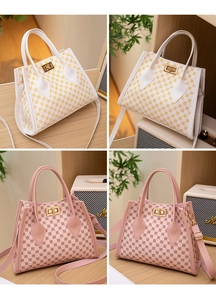 Detail view of printed tote bags with gold swivel locks in white yellow and pink tones