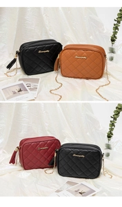 Detail of quilted leather bags in black and brown with gold chain and tassel accents