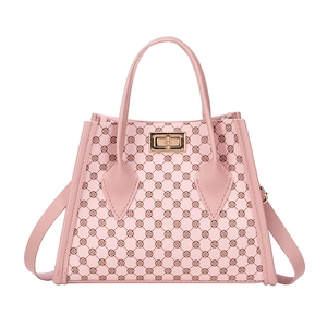 Pink monogram tote bag with gold lock buckle and adjustable shoulder strap for women
