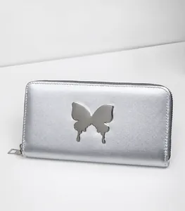 Detailed close-up of a long silver wallet featuring a metallic butterfly ornament and zip