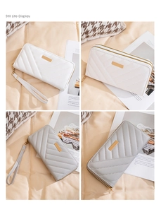 Detail of white and grey long quilted double-zipper wallets with elegant metal accents