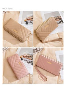 Close-up of quilted long wallets in khaki and pink with dual zippers and wrist straps
