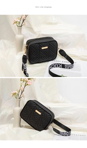 Macro shot of black quilted bag with herringbone stitching and a wide woven strap