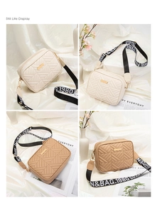 Detail of quilted camera bag with V-shaped stitching and adjustable wide logo strap